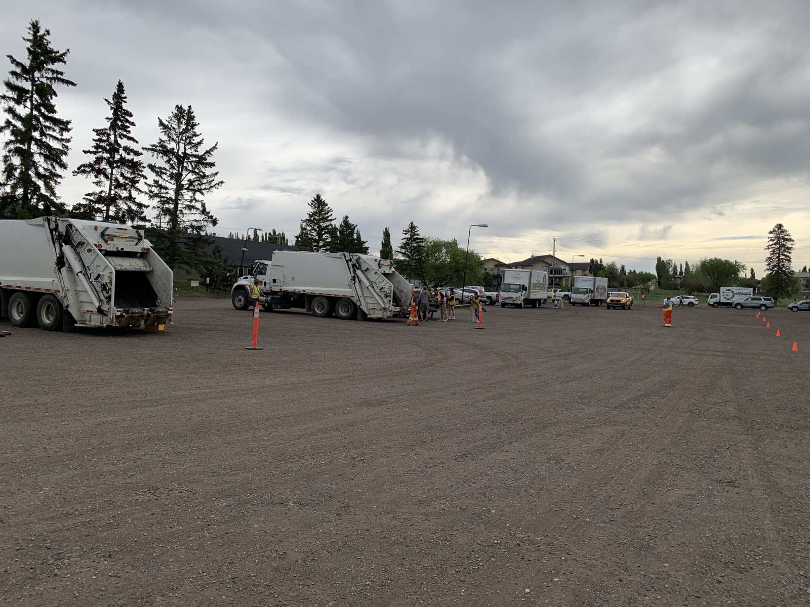 Two City of Calgary trucks being set up in the parking lot before the event opens.