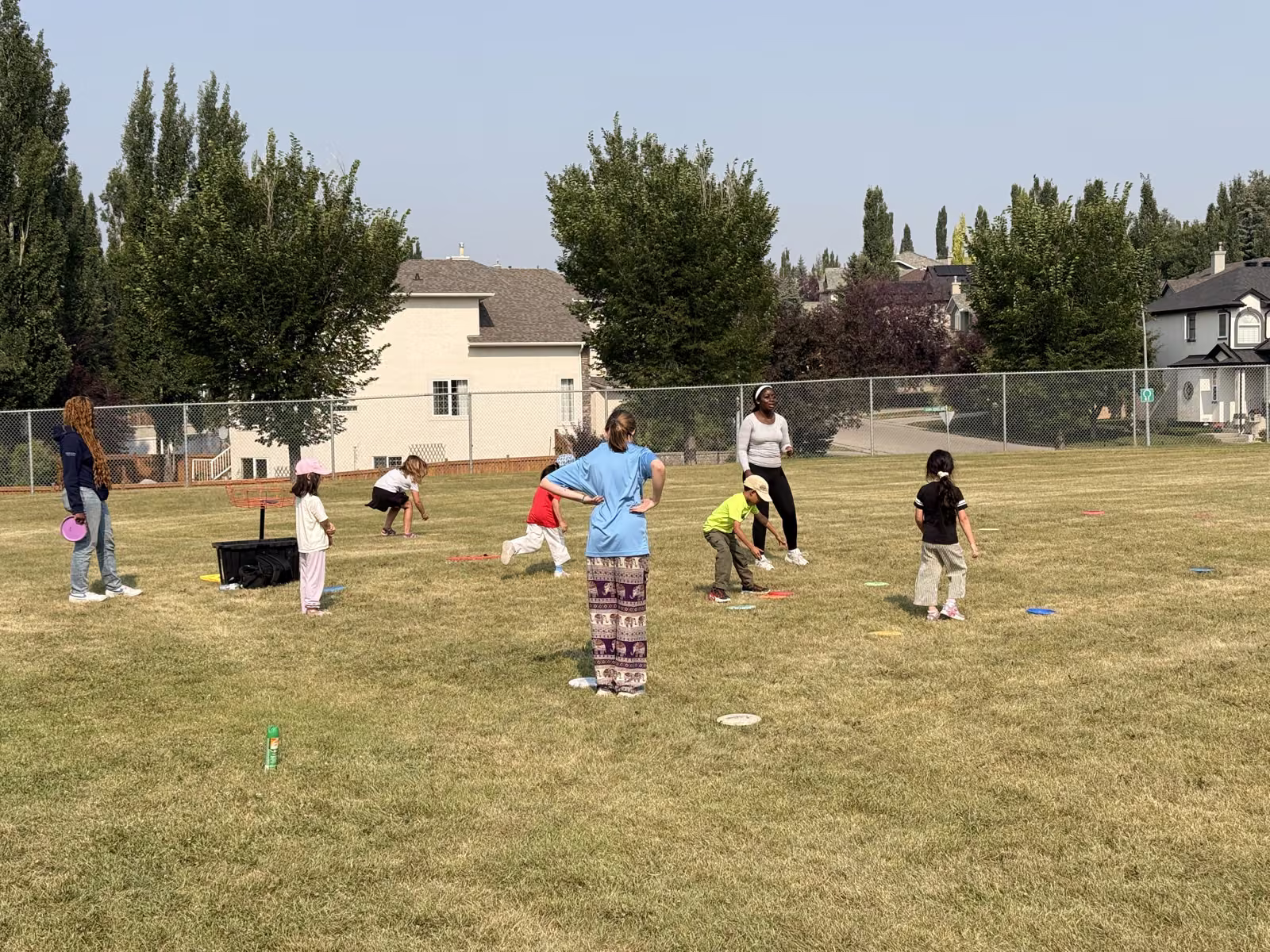 Kids playing a target game with rings spread across the field