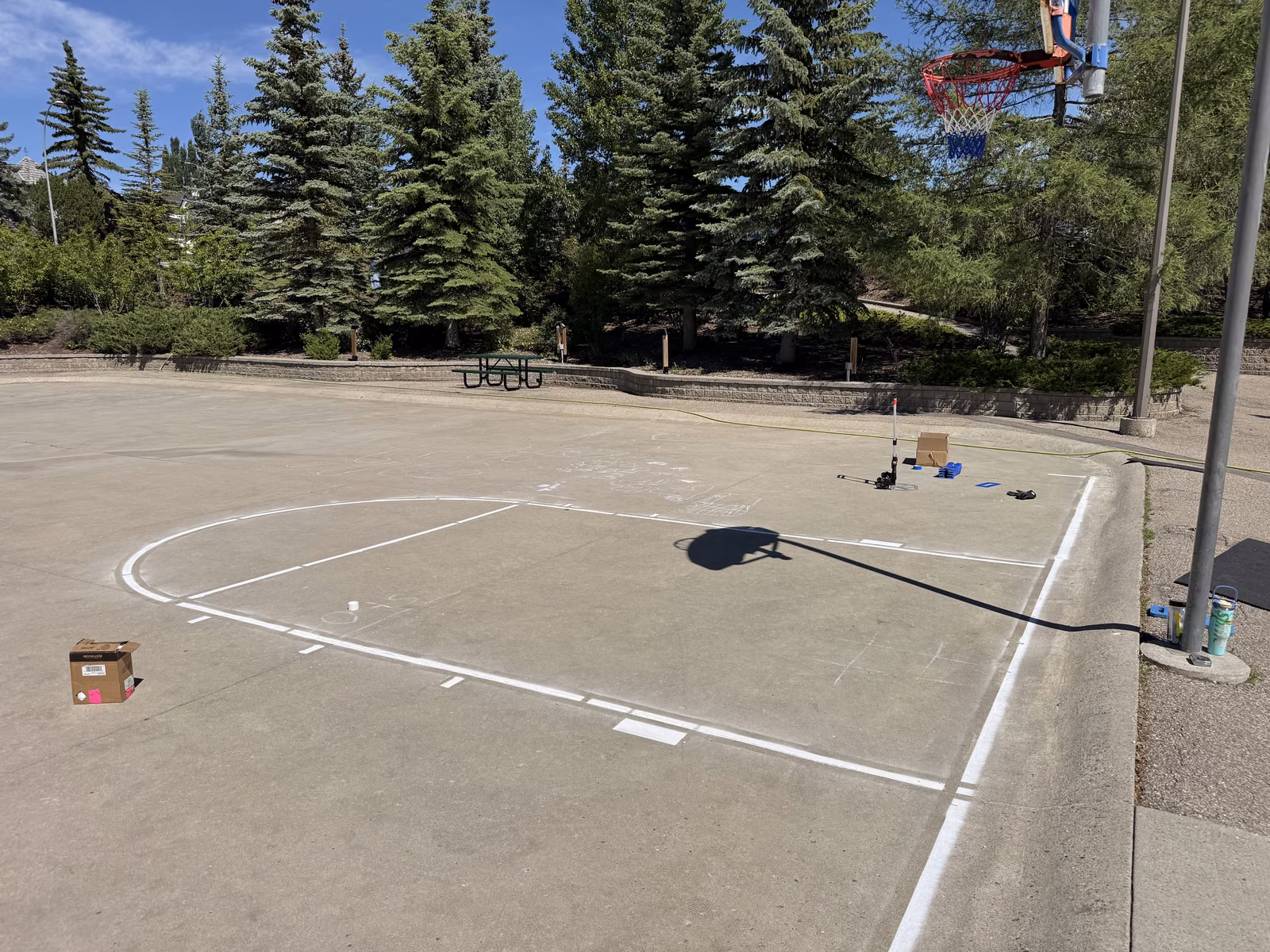 The finished basketball court with clean white lines and the key freshly painted