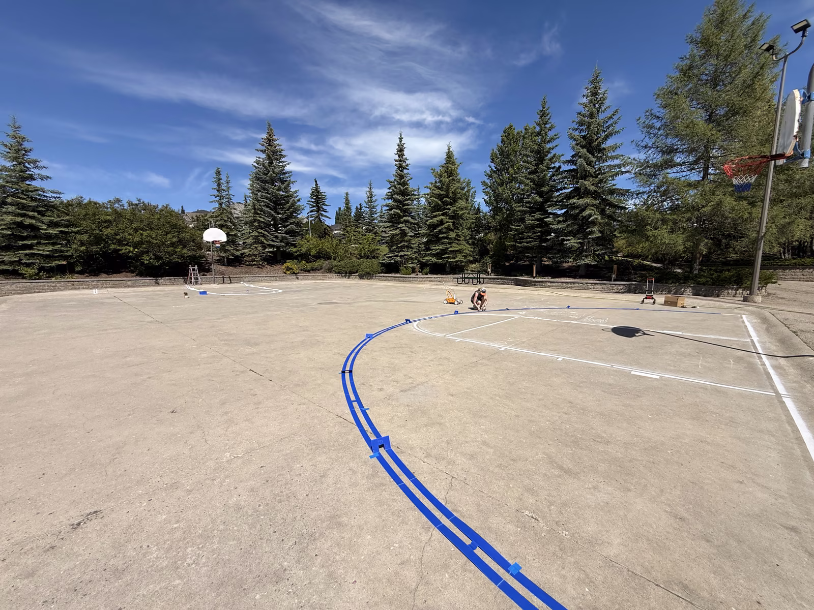 A sweeping taped curve laid out across the court surface